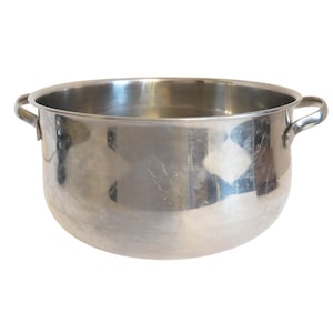 May include: A stainless steel cooking pot with two side handles. The pot has a wide, rounded body and a shiny, reflective surface. The pot is empty and sits against a white background.