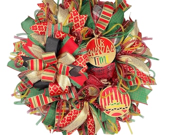 May include: A red, green, and gold wreath with a "It's Kwanzaa Time" sign and a Kwanzaa candle holder ornament.