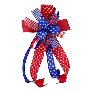 May include: A red, white, and blue bow with stars and checkered patterns. The bow is made of ribbon and is tied in a knot. It is a festive decoration for the Fourth of July or other patriotic holidays.