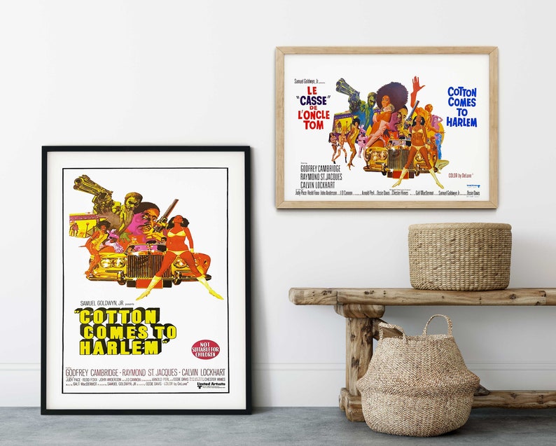 May include: A vintage movie poster for the film "Cotton Comes to Harlem" featuring a colourful illustration of a car with people standing on it. The poster is framed in black and has the title of the film in yellow letters.