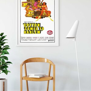 May include: A vintage movie poster for the film "Cotton Comes to Harlem" featuring a yellow car with a group of people in it. The poster has a yellow and orange colour scheme with black text. The text on the poster reads "Cotton Comes to Harlem" and "Not Suitable for Children".