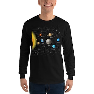 May include: A black long-sleeve t-shirt with a graphic of the solar system. The graphic shows the sun and all the planets in their orbits. The planets are labeled with their names.