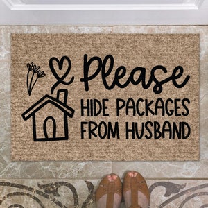May include: A brown doormat with the text "Please hide packages from husband" in black lettering. A heart and a house icon are also included in the design.