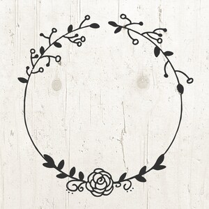 May include: A black and white floral wreath with a single rose at the bottom. The wreath is drawn in a simple, hand-drawn style.