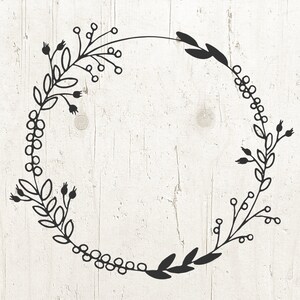 May include: Black and white floral wreath with a circular shape. The wreath is made of simple line drawings of leaves and berries.