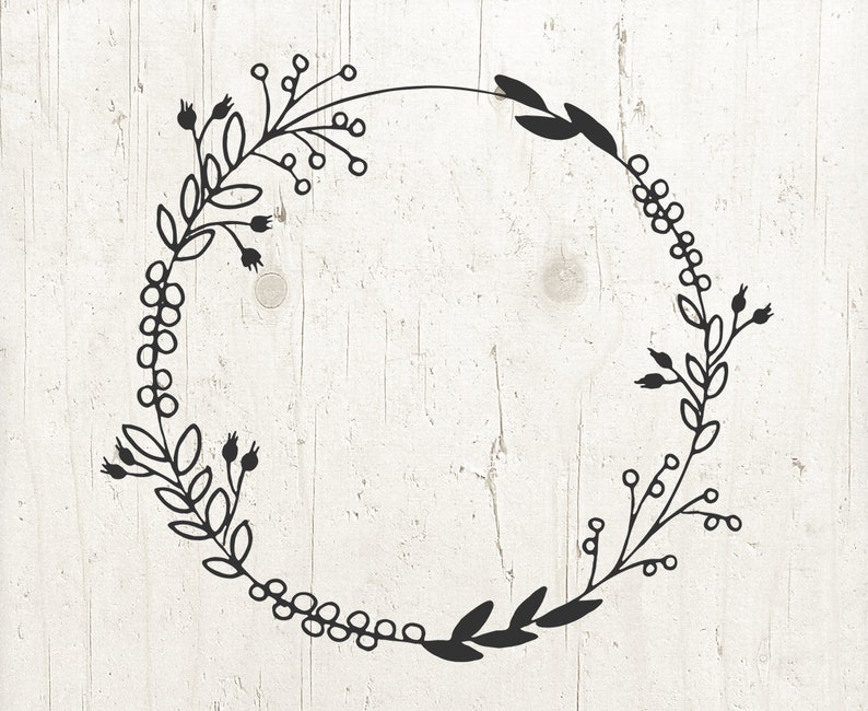 May include: Black and white floral wreath with a circular shape. The wreath is made of simple line drawings of leaves and berries.