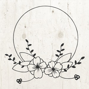 May include: A black and white floral wreath with a circle in the center. The wreath is made up of leaves and flowers.