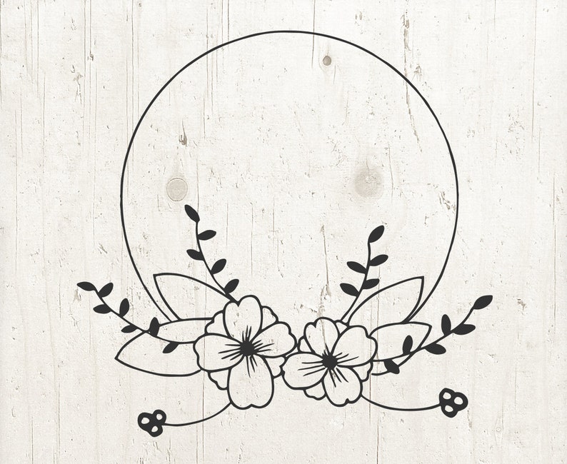 May include: A black and white floral wreath with a circle in the center. The wreath is made up of leaves and flowers.