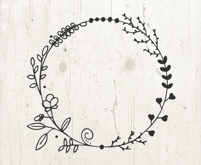 May include: Black and white floral wreath with a simple, delicate design. The wreath is made up of leaves, flowers, and vines.