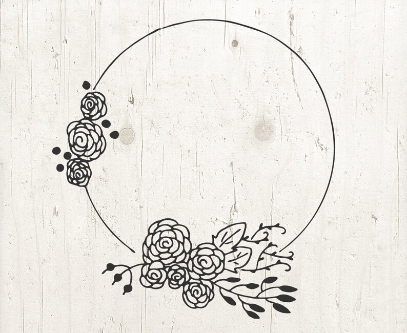 May include: A black and white floral wreath with a circle in the center. The wreath is made of stylized flowers and leaves.