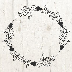 May include: A black and white wreath with a simple floral design. The wreath is made up of leaves and berries.