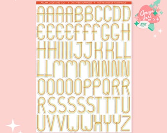 May include: A sheet of 70's vibe alphabet stickers with a rainbow colour scheme. The letters are outlined in white and have a retro, groovy style.