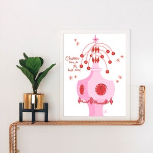 May include: A pink and red Christmas clock with a star on top and a quote that says "Christmas time is the best time!" The clock is surrounded by red and white stars.