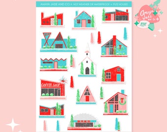 May include: A sheet of 16 Christmas-themed stickers featuring various red, blue, and pink houses with white snow accents. The stickers are designed in a retro style with a glittery texture. The text "Amaya Jade and Co. Not Weather or Waterproof Putz Houses" is printed at the top of the sheet.