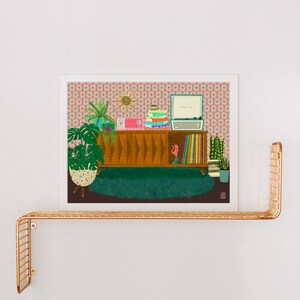 May include: A retro-style illustration of a mid-century modern living room with a wooden cabinet, a record player, and plants. The cabinet has a geometric pattern and is filled with records. The record player is playing a record. The plants are in pots and are green. The background is a pink and green patterned wallpaper.