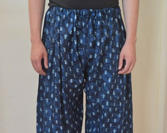 May include: Blue and white patterned pants with a loose, flowing fit. The pants have a drawstring waistband and are made of a soft, comfortable fabric.