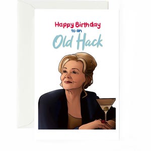 May include: A white greeting card featuring a digital illustration of an older woman with blonde hair wearing a dark jacket, holding a martini glass with an olive. The text reads Happy Birthday to an Old Hack in red and light blue lettering.