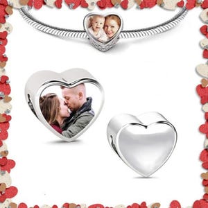 May include: Two silver heart-shaped charms with a photo insert. One charm features a couple kissing, the other charm features a mother and child.