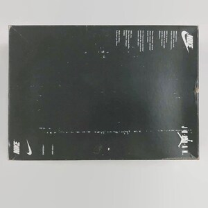 May include: Black shoebox with the Nike logo and the words "AIR JORDAN" on the side. The box is made of cardboard and has a white label on the bottom with the words "NIKE" and "MADE BY NIKE" printed on it.