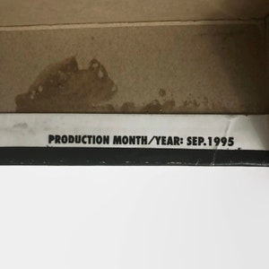 May include: Close-up of a white label with black text that reads "PRODUCTION MONTH/YEAR: SEP. 1995".