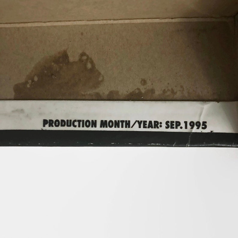 May include: Close-up of a white label with black text that reads "PRODUCTION MONTH/YEAR: SEP. 1995".