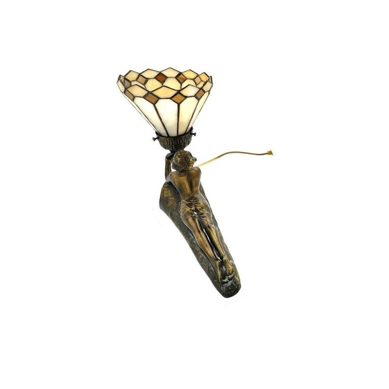 May include: A bronze wall sconce with a stained glass shade. The sconce features a reclining female figure holding the shade.