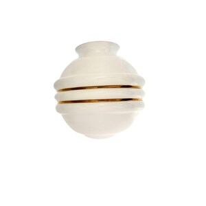 May include: A white, spherical vase with a rounded body and a narrow neck. The vase features two horizontal gold bands that encircle the body. The design is minimalist and elegant, suitable for home decor.