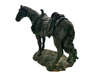 May include: Black horse figurine with a saddle and bridle, standing on a rocky base.