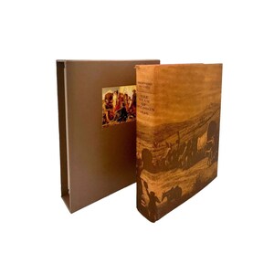 May include: A brown leather-bound book titled "The Year of Decision 1846" by Bernard DeVoto. The book cover features a vintage illustration of a wagon train traveling across a dusty landscape.
