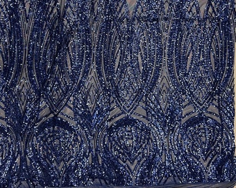 May include: Navy blue sequined fabric with a geometric pattern. The sequins are small and create a shimmering effect.
