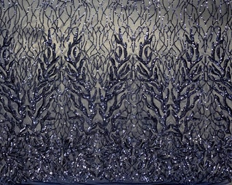 May include: Navy blue sequined fabric with a delicate floral pattern. The sequins are small and create a shimmering effect. The fabric is sheer and has a soft, flowing texture.