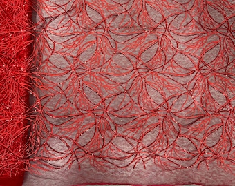May include: Red beaded lace fabric with a floral pattern. The fabric has a delicate, sheer texture and is perfect for adding a touch of elegance to any project.