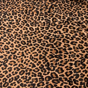May include: Brown and black leopard print fabric with a soft, fuzzy texture.