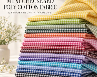May include: A stack of folded poly-cotton fabric featuring a mini checkered pattern with 1/4 inch checks. The fabric is available in 17 colors, including yellow, green, orange, pink, red, purple, blue, and black, labeled as Carly Mini Checkered Poly Cotton Fabric.