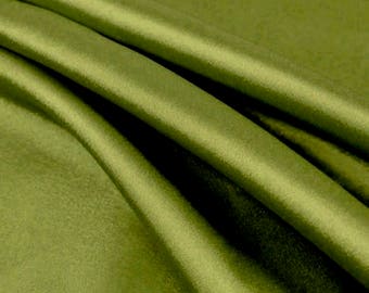 May include: A close-up of a smooth, olive green fabric with a silky sheen. The fabric is folded in a way that shows its drape and texture.