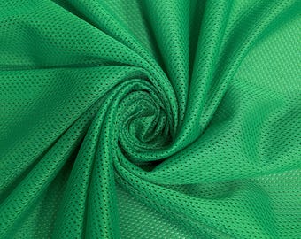 May include: Close-up of a vibrant green mesh fabric, tightly woven with small, evenly spaced holes. The fabric is draped and swirled, creating soft folds and shadows. The texture is visible, highlighting its breathable and lightweight nature. Ideal for athletic wear.