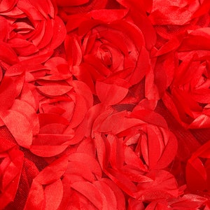 May include: A close-up of a red fabric with a textured rose pattern. The fabric is made of many layers of petals, creating a 3D effect.