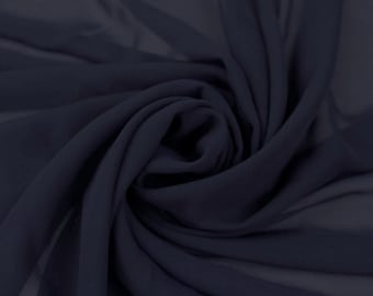 May include: A close-up of a dark blue fabric with a soft, flowing texture. The fabric is draped and folded, creating a smooth, elegant look.