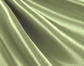 May include: A close-up of a smooth, silky fabric in a muted green color. The fabric is draped and folded, showcasing its soft texture and subtle sheen.