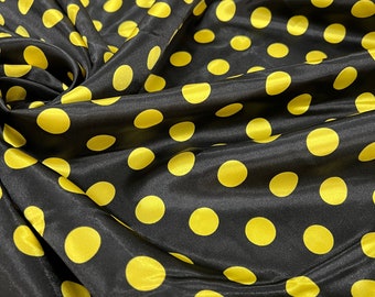 May include: Black fabric with a repeating pattern of large yellow polka dots.