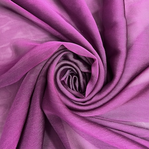 May include: A close-up of a deep purple sheer fabric, draped and folded to create a soft, flowing texture.