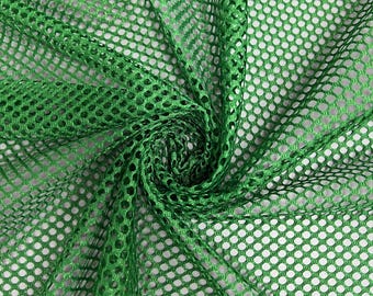 May include: Green mesh fabric with a diamond pattern. The fabric is folded and twisted, showing the texture of the mesh.