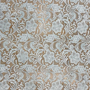 May include: A delicate white lace fabric with a floral pattern in a light blue color. The lace has a delicate, intricate design with small flowers and leaves.