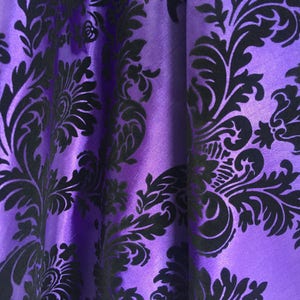 May include: Purple fabric with a black damask pattern. The fabric has a subtle sheen and a soft texture.