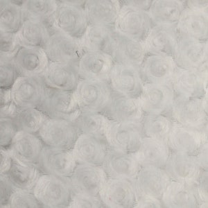 May include: White fabric with a textured swirl pattern. The fabric has a soft, fuzzy texture.