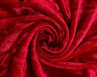 May include: Close-up of a deep red velvet fabric with a swirling pattern.
