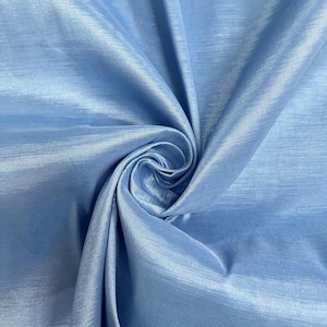 May include: Close-up of a light blue fabric with a subtle sheen. The fabric is gathered and swirled, creating a textured effect. The material appears to be lightweight and flowing, suitable for apparel or home decor.