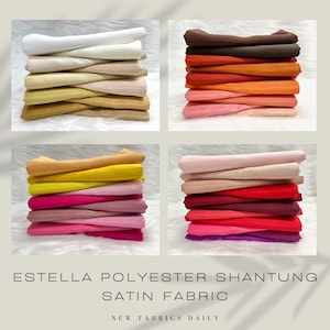 May include: A stack of colourful polyester shantung satin fabric in various shades of white, brown, orange, yellow, pink, red, and purple. The fabric is arranged in a grid of four squares. The text "Estela Polyester Shantung Satin Fabric" is at the bottom of the image.