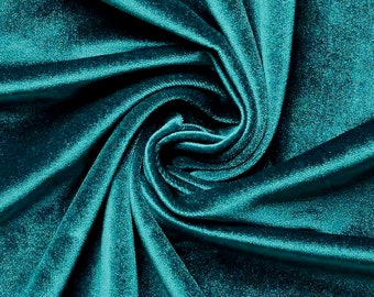 May include: Teal velvet fabric with a soft, smooth texture. The fabric is folded and draped, creating a luxurious and elegant look.