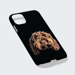 May include: Black phone case with a brown and white dog's face on it. The dog's face is stylized with a glowing effect.